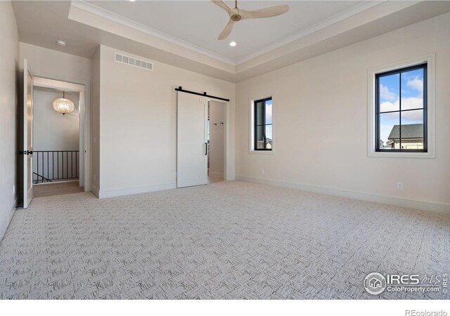 951 Warbling Dr, Windsor, CO 80550 - unfurnished bedroom with multiple windows, a barn door, carpet, ornamental molding, and recessed lighting