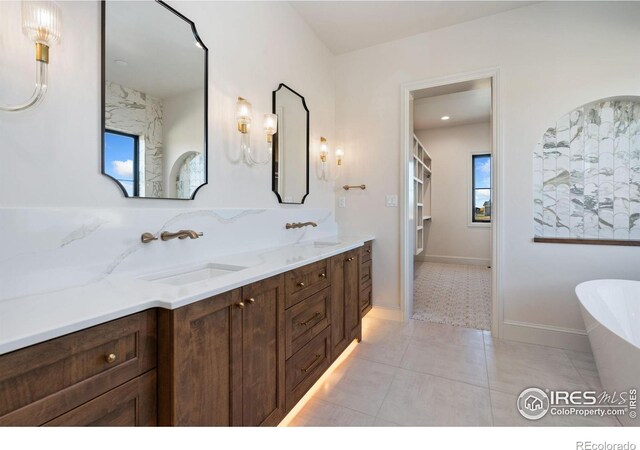 951 Warbling Dr, Windsor, CO 80550 - bathroom with a soaking tub, double vanity, and tile patterned floors