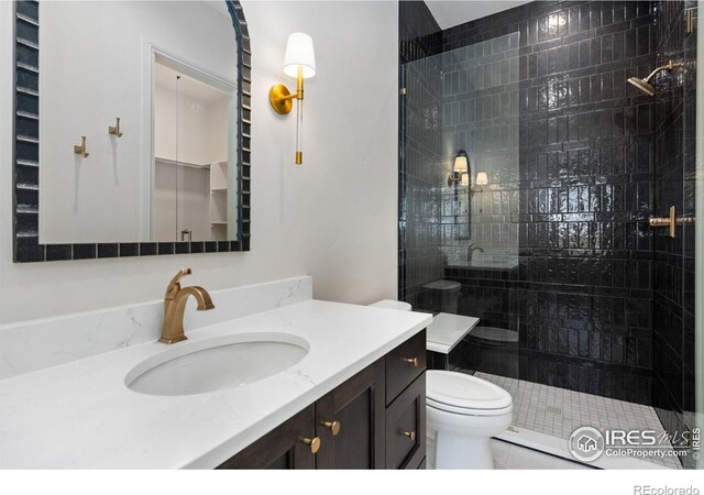 951 Warbling Dr, Windsor, CO 80550 - bathroom featuring tiled shower, toilet, and vanity