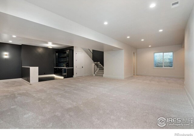 951 Warbling Dr, Windsor, CO 80550 - below grade area featuring stairs, carpet, recessed lighting, and baseboards
