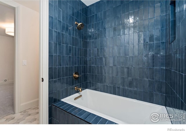 951 Warbling Dr, Windsor, CO 80550 - bathroom featuring tiled shower / bath combo and baseboards