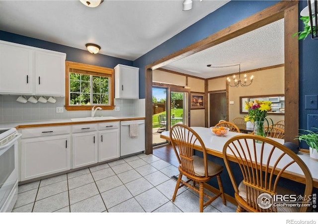5930 Mars Dr, Fort Collins, CO 80525 - kitchen featuring white appliances, a sink, backsplash, light countertops, and light tile patterned floors