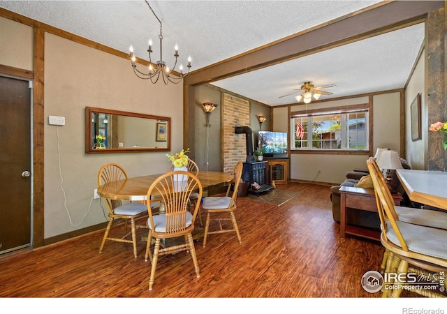 5930 Mars Dr, Fort Collins, CO 80525 - dining space featuring a wood stove, a textured ceiling, wood finished floors, baseboards, and ornamental molding