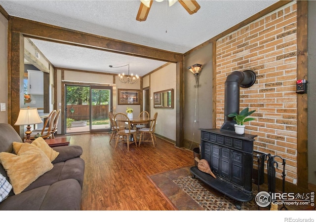 5930 Mars Dr, Fort Collins, CO 80525 - living room with a wood stove, wood finished floors, a textured ceiling, a chandelier, and a ceiling fan