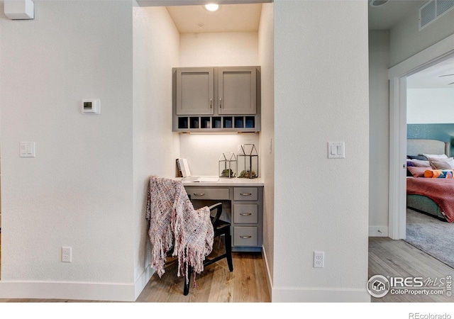 office area featuring light wood finished floors and baseboards