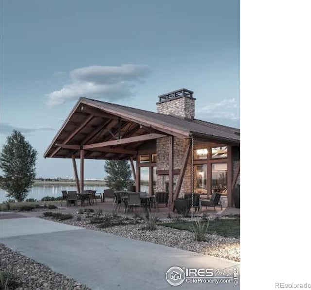 view of patio / terrace with a carport and a water view