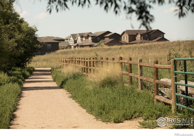 view of yard featuring fence and a residential view