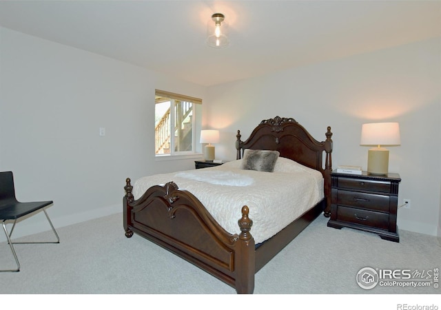 carpeted bedroom featuring baseboards