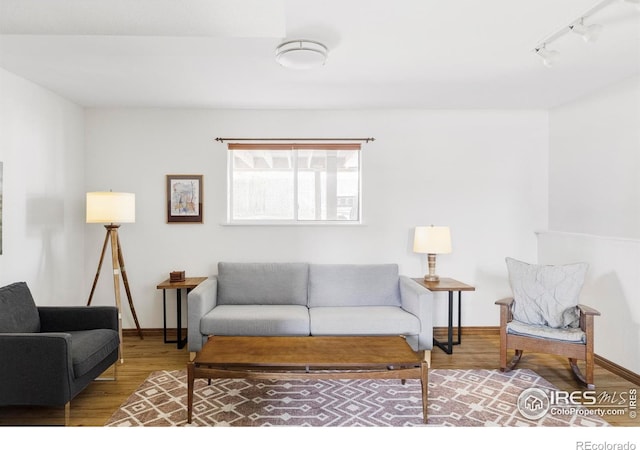 1013 Alsace Way, Lafayette, CO 80026 - living room featuring wood finished floors, rail lighting, and baseboards