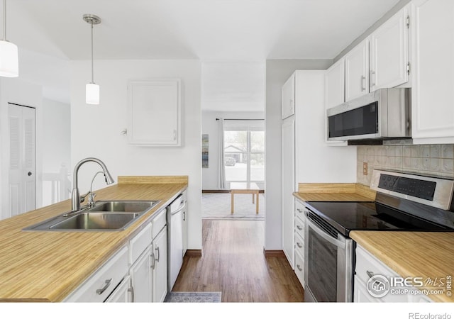1013 Alsace Way, Lafayette, CO 80026 - kitchen with stainless steel appliances, a sink, dark wood finished floors, and white cabinetry