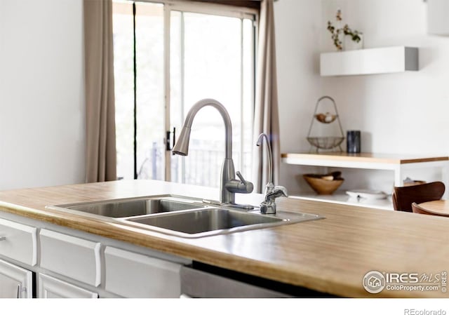 1013 Alsace Way, Lafayette, CO 80026 - kitchen with a sink, white cabinets, and light countertops