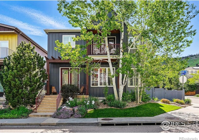 5145 Denver St, Boulder, CO 80304 - view of front facade featuring a balcony, board and batten siding, and fence