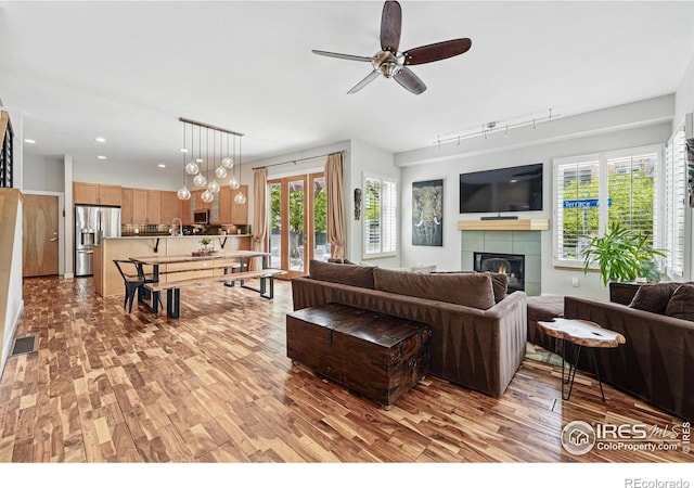 5145 Denver St, Boulder, CO 80304 - living area featuring light wood-style floors, track lighting, ceiling fan, a fireplace, and recessed lighting