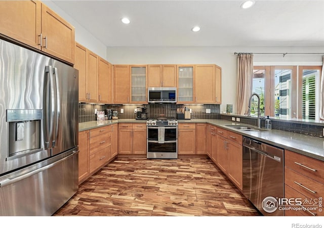 5145 Denver St, Boulder, CO 80304 - kitchen featuring appliances with stainless steel finishes, a sink, wood finished floors, recessed lighting, and backsplash