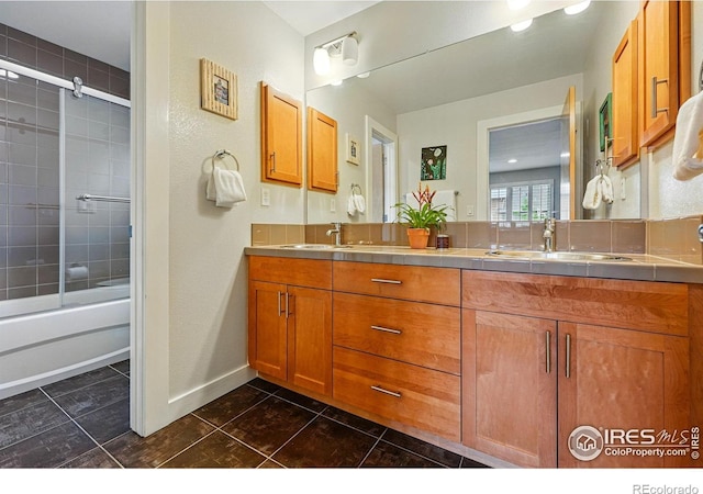 5145 Denver St, Boulder, CO 80304 - full bathroom with double vanity, bath / shower combo with glass door, baseboards, and tile patterned flooring