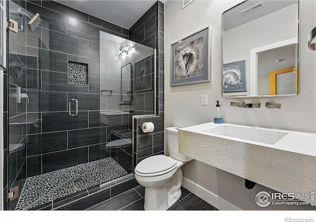 5145 Denver St, Boulder, CO 80304 - full bath featuring toilet, a shower stall, baseboards, and tile patterned flooring