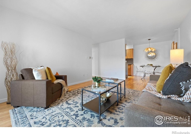 living room with light wood-type flooring and baseboards