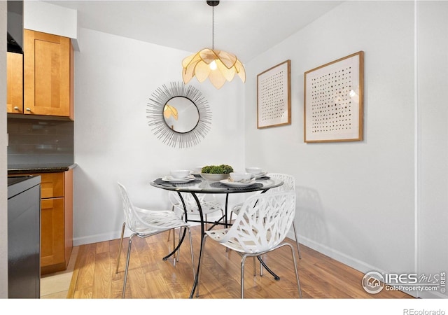 dining room with light wood-style floors and baseboards