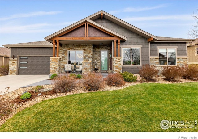 660 Deer Meadow Dr, Loveland, CO 80537 - view of front of home featuring a front lawn, stone siding, and a garage