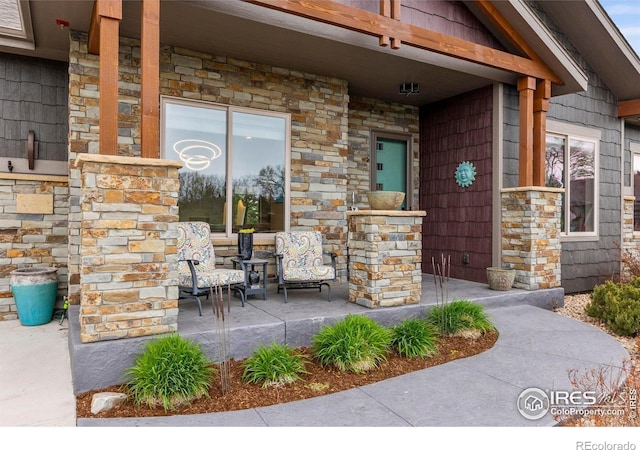 660 Deer Meadow Dr, Loveland, CO 80537 - doorway to property with covered porch and stone siding