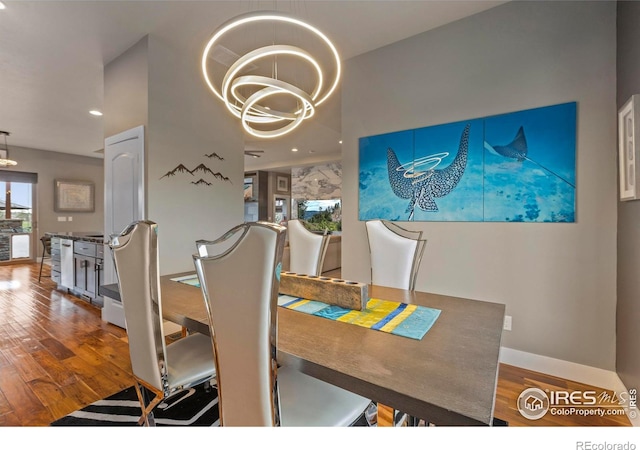660 Deer Meadow Dr, Loveland, CO 80537 - dining space with a chandelier, wood finished floors, recessed lighting, and baseboards