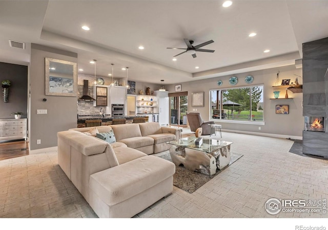 660 Deer Meadow Dr, Loveland, CO 80537 - living room featuring a raised ceiling, recessed lighting, baseboards, and a ceiling fan