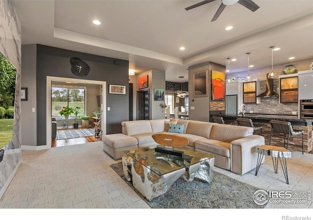 660 Deer Meadow Dr, Loveland, CO 80537 - living room with a raised ceiling, recessed lighting, ceiling fan, and baseboards