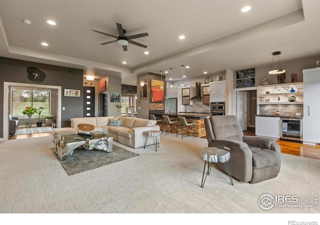 660 Deer Meadow Dr, Loveland, CO 80537 - living area featuring beverage cooler, a tray ceiling, a ceiling fan, and recessed lighting