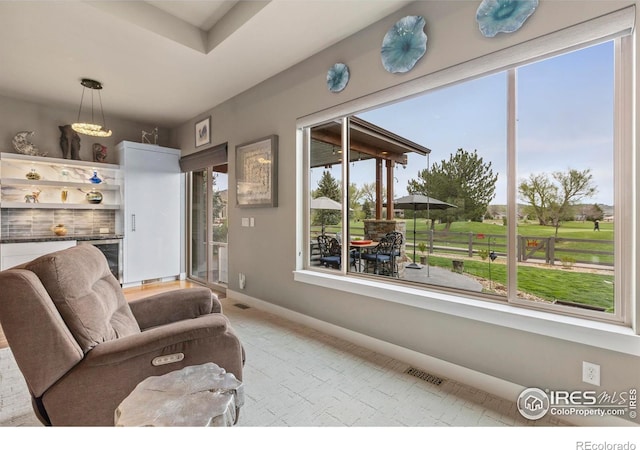 660 Deer Meadow Dr, Loveland, CO 80537 - living room featuring light colored carpet, baseboards, and a bar
