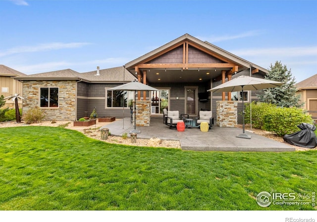 660 Deer Meadow Dr, Loveland, CO 80537 - back of property with a patio area, stone siding, and a yard