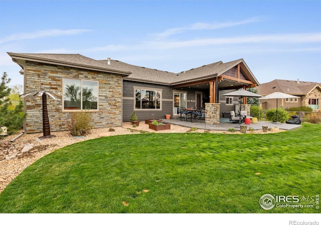 660 Deer Meadow Dr, Loveland, CO 80537 - rear view of house featuring a patio area, stone siding, a yard, and roof with shingles