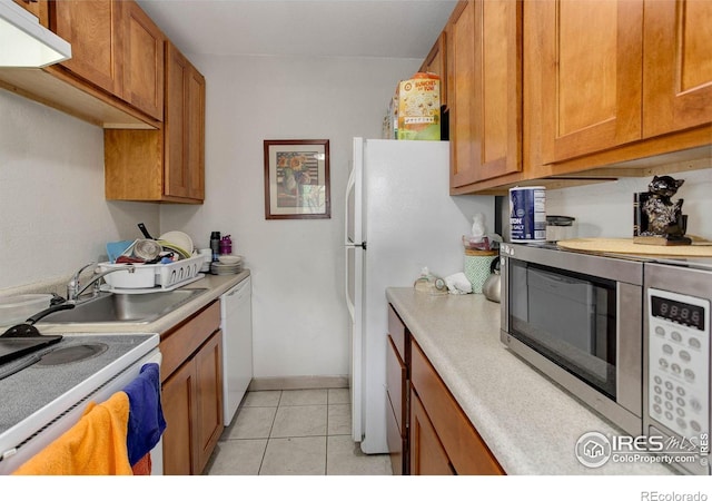 3030 Oneal Pkwy Unit 10, Boulder, CO 80301 - kitchen featuring white appliances, a sink, brown cabinetry, and light countertops