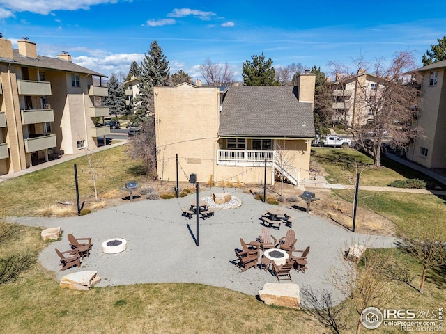 3030 Oneal Pkwy Unit 10, Boulder, CO 80301 - rear view of house featuring a fire pit, a chimney, a shingled roof, a patio, and stairs