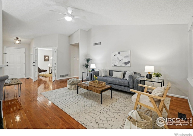 1970 Hamron Ct, Erie, CO 80516 - living room featuring vaulted ceiling, ceiling fan, hardwood / wood-style flooring, a textured ceiling, and baseboards