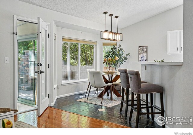 1970 Hamron Ct, Erie, CO 80516 - dining room with a textured ceiling and dark wood-type flooring