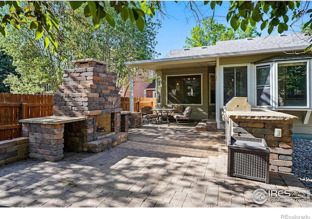 1970 Hamron Ct, Erie, CO 80516 - view of patio with exterior fireplace, a fenced backyard, outdoor dining area, and a grill
