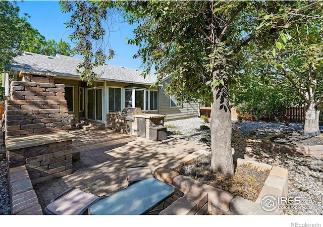 1970 Hamron Ct, Erie, CO 80516 - view of patio / terrace with an outdoor kitchen, fence, and a grill