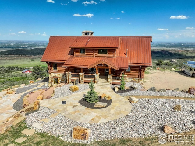 9126 Gold Mine Rd, Loveland, CO 80538 - log-style house with stone siding, log siding, metal roof, and a porch