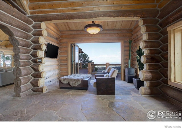 9126 Gold Mine Rd, Loveland, CO 80538 - interior space featuring stone flooring, rustic walls, wooden ceiling, and beamed ceiling
