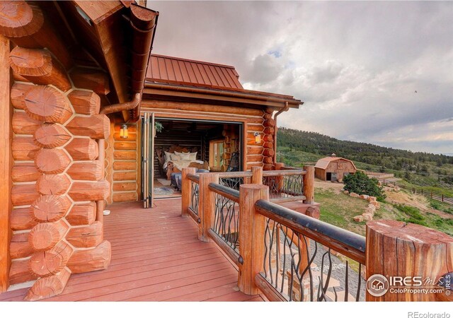 9126 Gold Mine Rd, Loveland, CO 80538 - wooden terrace featuring a barn and an outbuilding
