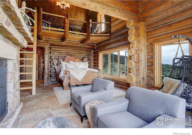 9126 Gold Mine Rd, Loveland, CO 80538 - bedroom with multiple windows, rustic walls, and stone finish flooring