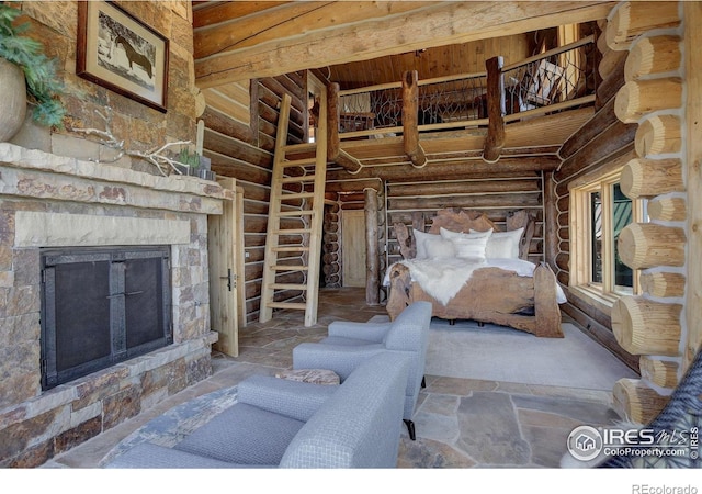 9126 Gold Mine Rd, Loveland, CO 80538 - unfurnished bedroom with rustic walls and an outdoor stone fireplace