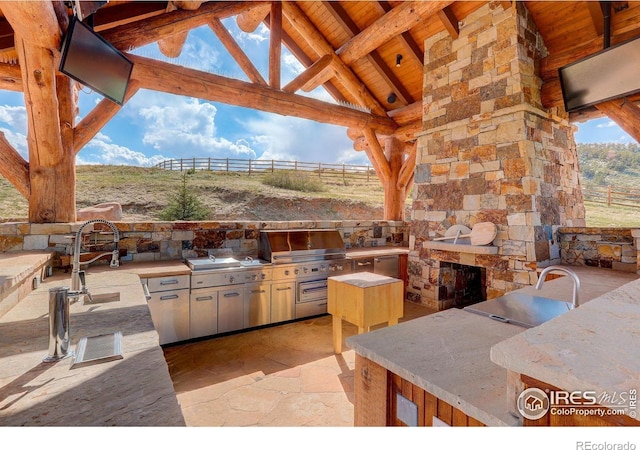9126 Gold Mine Rd, Loveland, CO 80538 - view of patio featuring a gazebo, exterior kitchen, fence, area for grilling, and a sink