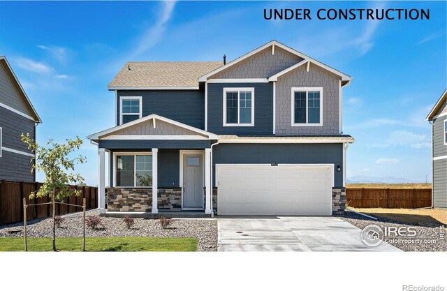 4204 Sandstone Dr, Mead, CO 80504 - craftsman house with covered porch, stone siding, driveway, and a garage