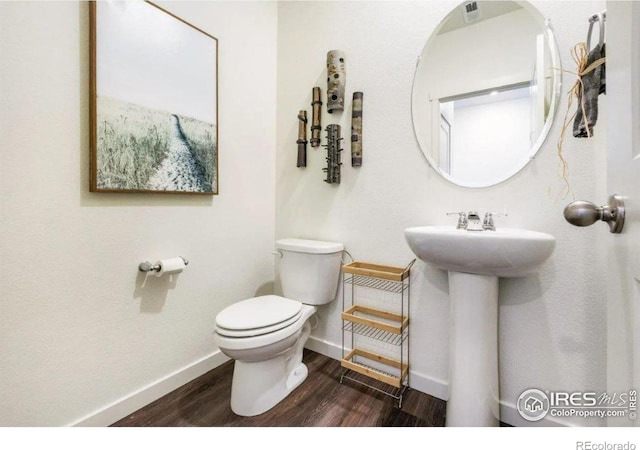 4204 Sandstone Dr, Mead, CO 80504 - half bathroom featuring wood finished floors, toilet, and baseboards