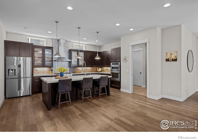 3663 Silverton St, Boulder, CO 80301 - kitchen with appliances with stainless steel finishes, wall chimney range hood, light countertops, backsplash, and recessed lighting