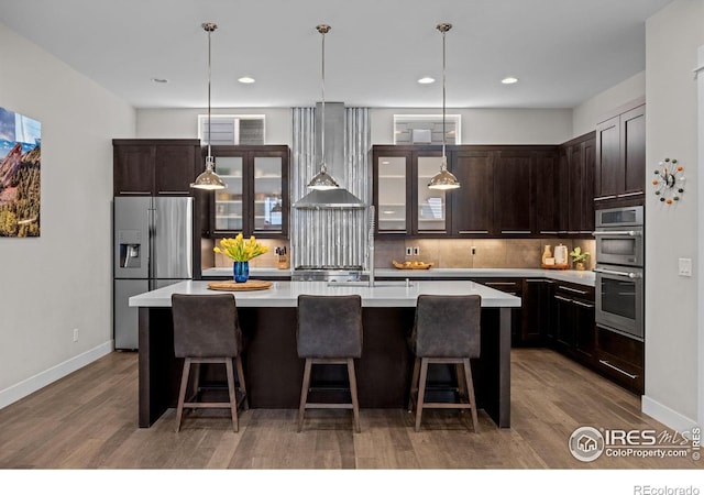 3663 Silverton St, Boulder, CO 80301 - kitchen with stainless steel appliances, decorative backsplash, dark brown cabinetry, light countertops, and wood finished floors