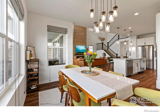 dining space featuring dark wood-style flooring, plenty of natural light, stairway, and recessed lighting
