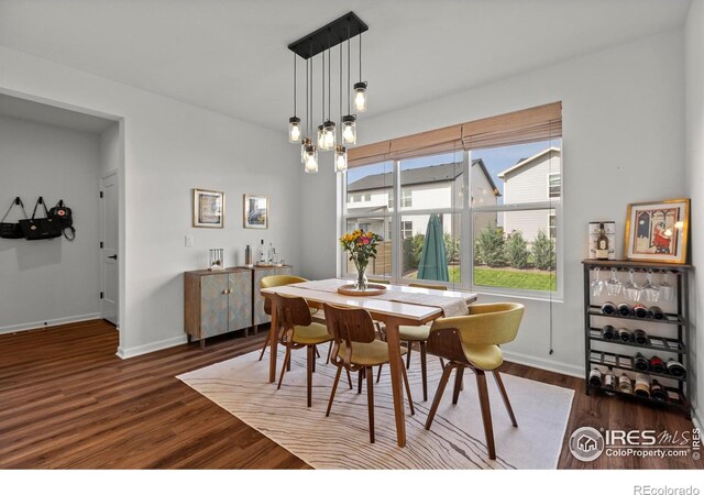 dining area featuring wood finished floors and baseboards