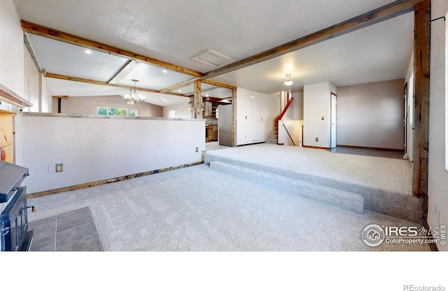 below grade area featuring baseboards, carpet floors, freestanding refrigerator, and stairway